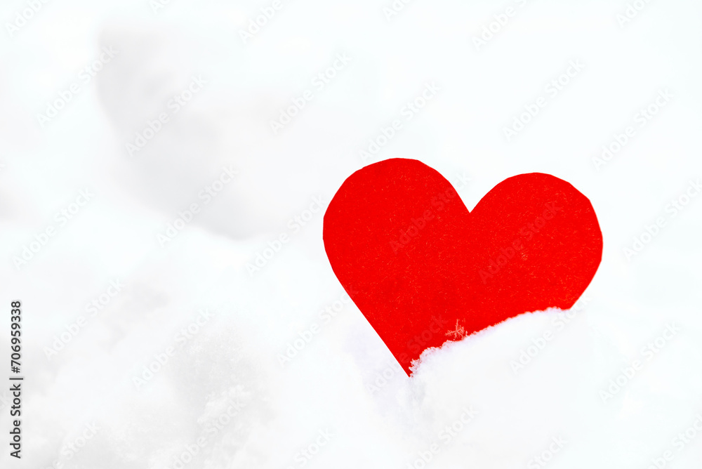 Red hearts in snow in winter. Love concept.