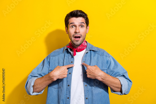 Photo portrait of handsome young guy fingers point self astonished wear trendy jeans outfit isolated on yellow color background photo
