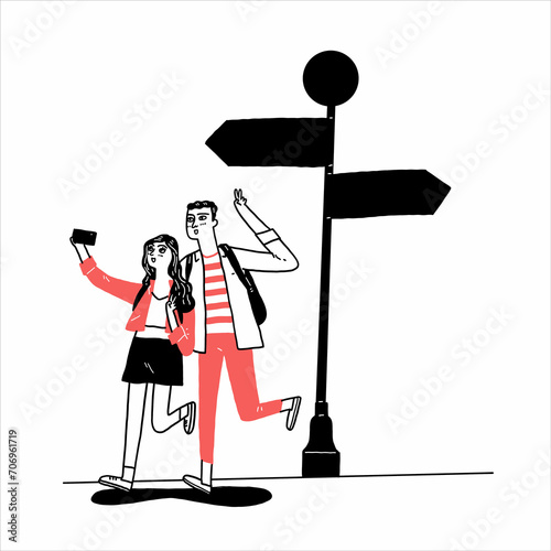 A tourist couple takes a selfie with a road sign.