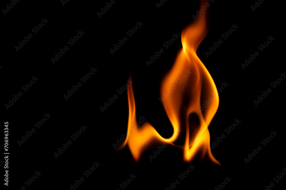 Hot flames on a black background. Beautiful flame of fire in the dark. Abstract of burning flames and smoke. Hot flames on a black background. Beautiful flame of fire in the dark. Abstract of burning flames and smoke.