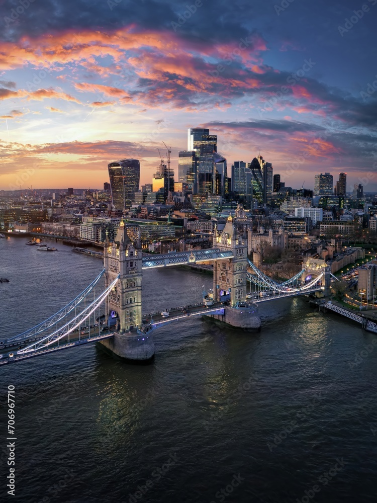 Aerial sunset view of the famous Tower Bridge in London and the skyscrapers of the city in the background, England