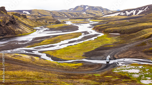 Foto Campervan crossing a river in wild nature of Iceland