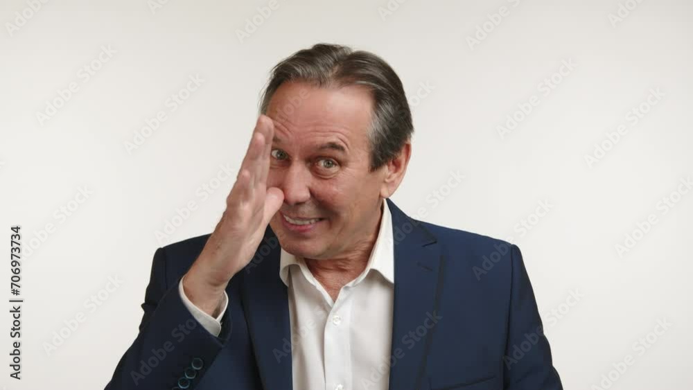 Elegant man in business attire playfully making funny faces. He is in a playful mood. Middle-aged man with black hair. White background. Camera 8K RAW. Elegant man in business attire playfully making funny faces. He is in a playful mood. Middle-aged man with black hair. White background. Camera 8K RAW.