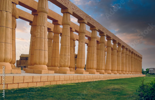 Sunrise Over Majestic Egyptian-Style Columns with Hieroglyphs in a Modern Historical Park