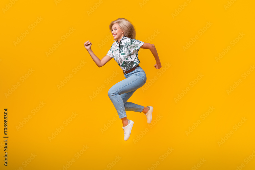 Full size photo of fast active girl dressed print shirt running look at proposition empty space isolated on yellow color background Full size photo of fast active girl dressed print shirt running look at proposition empty space isolated on yellow color background