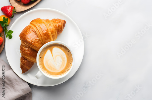 Cup of coffee and croissants on white background top view