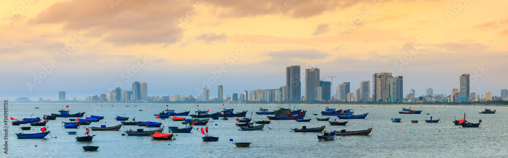 Naklejka premium Fishing boats at My Khe beach with sunrise in Danang , Vietnam, Bamboo basket boat, Local fishing boats in Vietnam