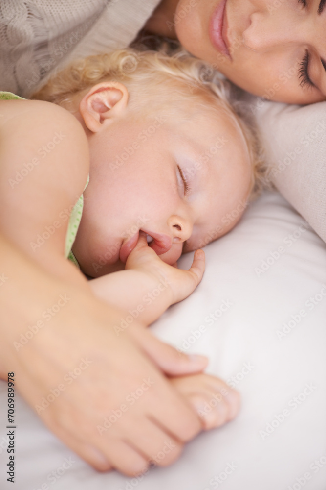 Mother, baby and kid suck thumb in home, adorable and cute innocent child with parent in house. Young blonde toddler, finger and mouth of healthy little girl sleeping in bedroom together with mama Mother, baby and kid suck thumb in home, adorable and cute innocent child with parent in house. Young blonde toddler, finger and mouth of healthy little girl sleeping in bedroom together with mama