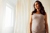 Studio shot of a woman who is expecting a baby