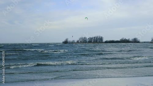 Kitesurfing, kiteboarding in wintertime, Ijsselmeer, Netherlands