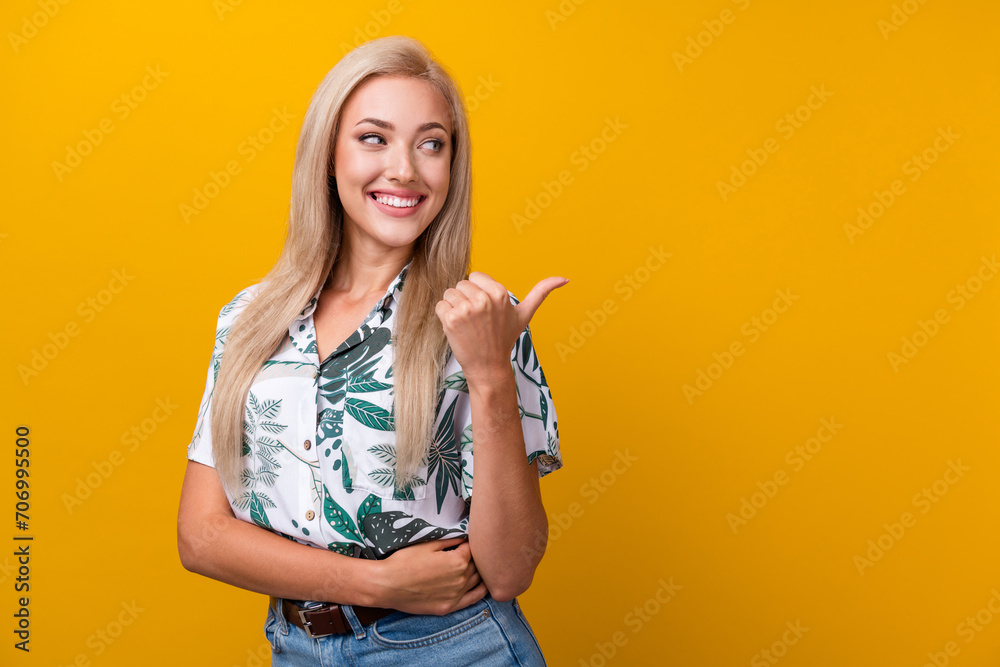 Portrait of lovely girlish woman with straight hair wear blouse look directing at promo empty space isolated on yellow color background Portrait of lovely girlish woman with straight hair wear blouse look directing at promo empty space isolated on yellow color background