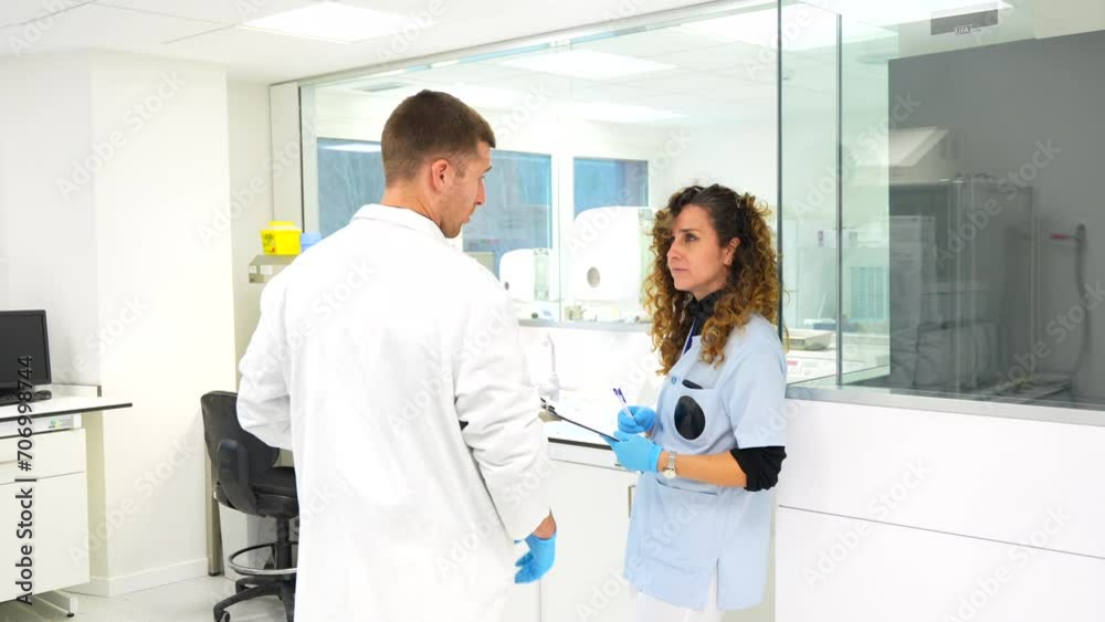 Scientists writing data working in a research laboratory in an hospital Scientists writing data working in a research laboratory in an hospital