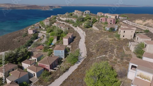 Fly Over Seafront Villas On The Abandoned Hotel In The Ghost Town Of Lemnos Island, Greece. Aerial Drone Shot photo