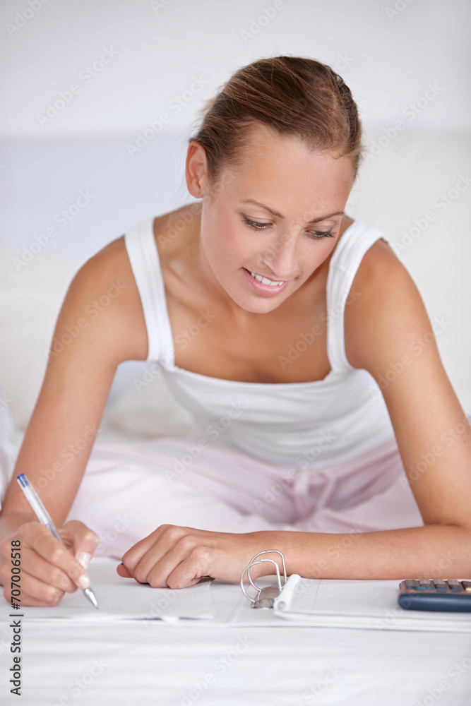 Happy woman, writing and documents in bed for budget planning, expenses or finance at home. Female person smile with notebook or calculator for morning or financial checklist in bedroom at house Happy woman, writing and documents in bed for budget planning, expenses or finance at home. Female person smile with notebook or calculator for morning or financial checklist in bedroom at house