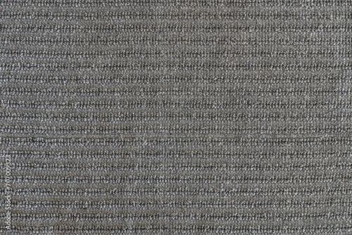 abstract background of grey furniture upholstery with ribbed trim texture close up