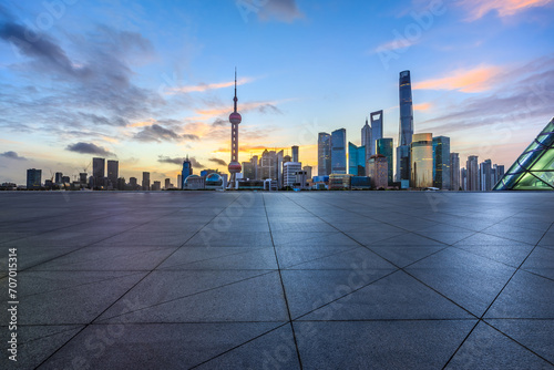 Empty square floor and modern city building landsca pe at sunrise in Shanghai