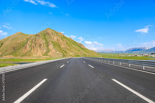 Country road and mountain nature landscape under the blue sky