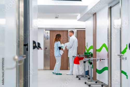 Nurse and doctor taking in the corridor of an hospital
