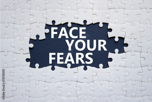 Face your Fears symbol. Concept words Face your Fears on white puzzle. Beautiful deep blue background. Business and Face your Fears. Copy space. photo