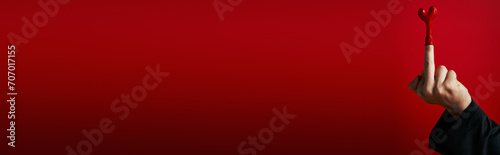 Картината върху платно cropped banner of provocative man showing middle finger with balloon on red back
