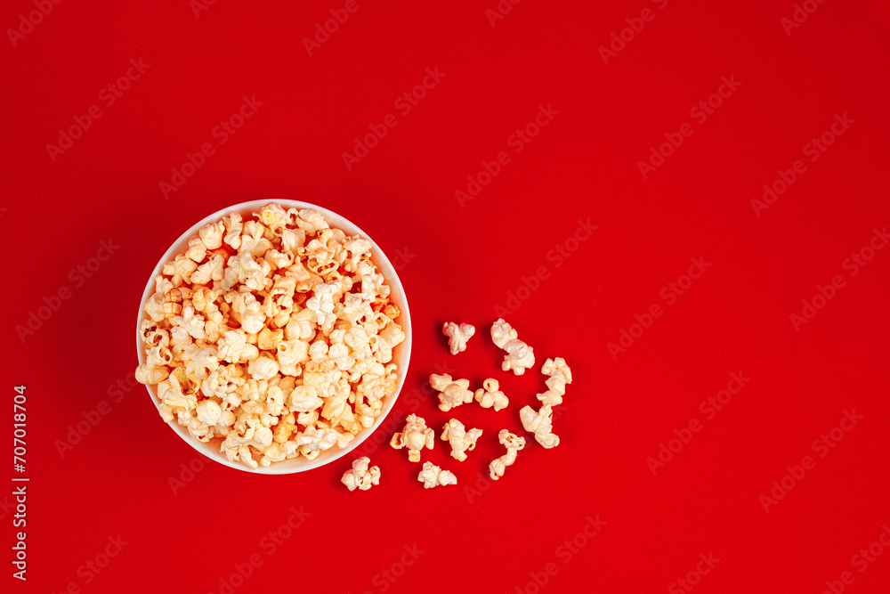 plate with popcorn on a red background plate with popcorn on a red background