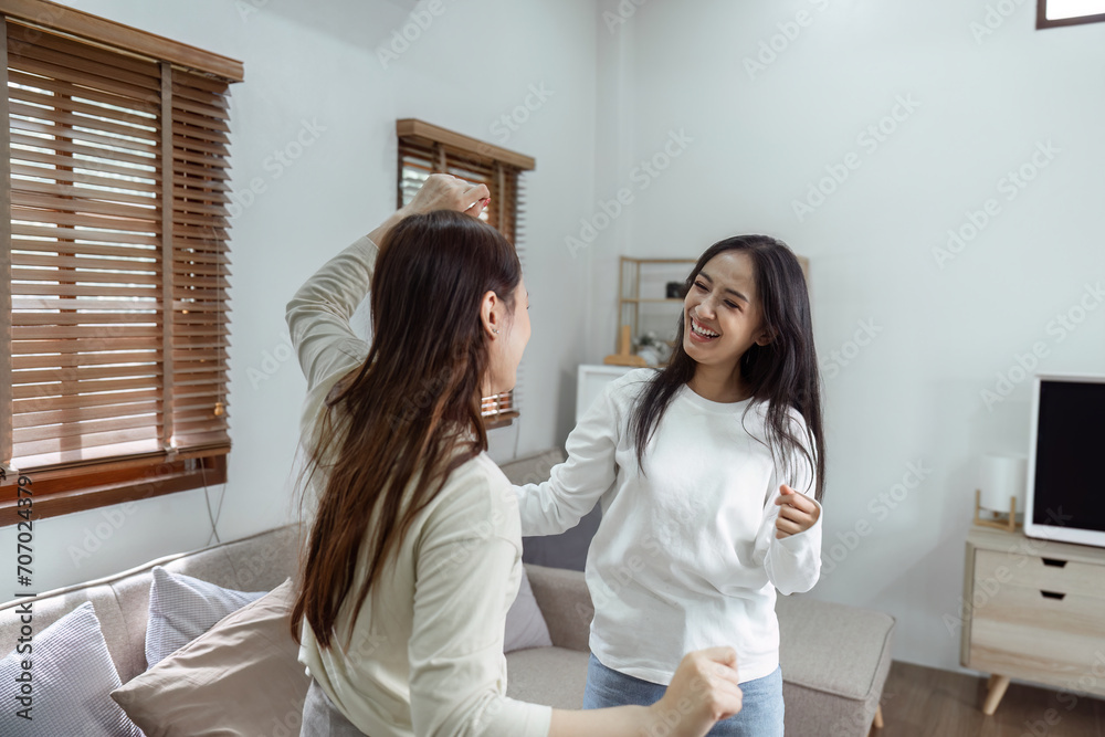 Young lesbian romantic couple in love dancing spending time together at home Young lesbian romantic couple in love dancing spending time together at home