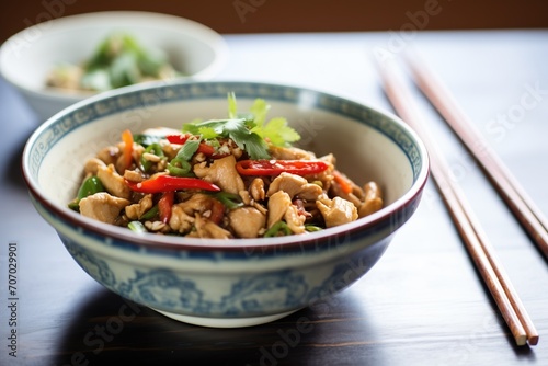 freshly cooked kung pao chicken in a ceramic bowl