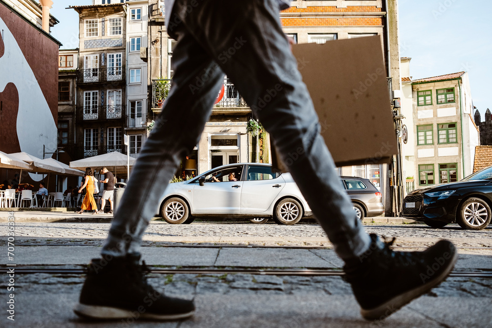 Street full of life - people, cars in a move in Porto, Portugal