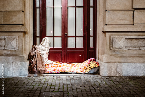 Bed of homeless person in front of urban house, Porto, Portugal