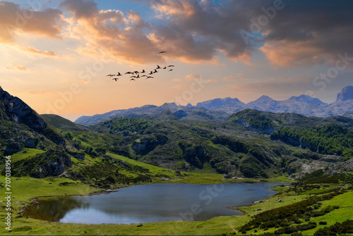 Golden Hour Serenity at Tranquil Lake, Lush Valley with Reflective Waters, Birds in Flight, Scenic Mountains