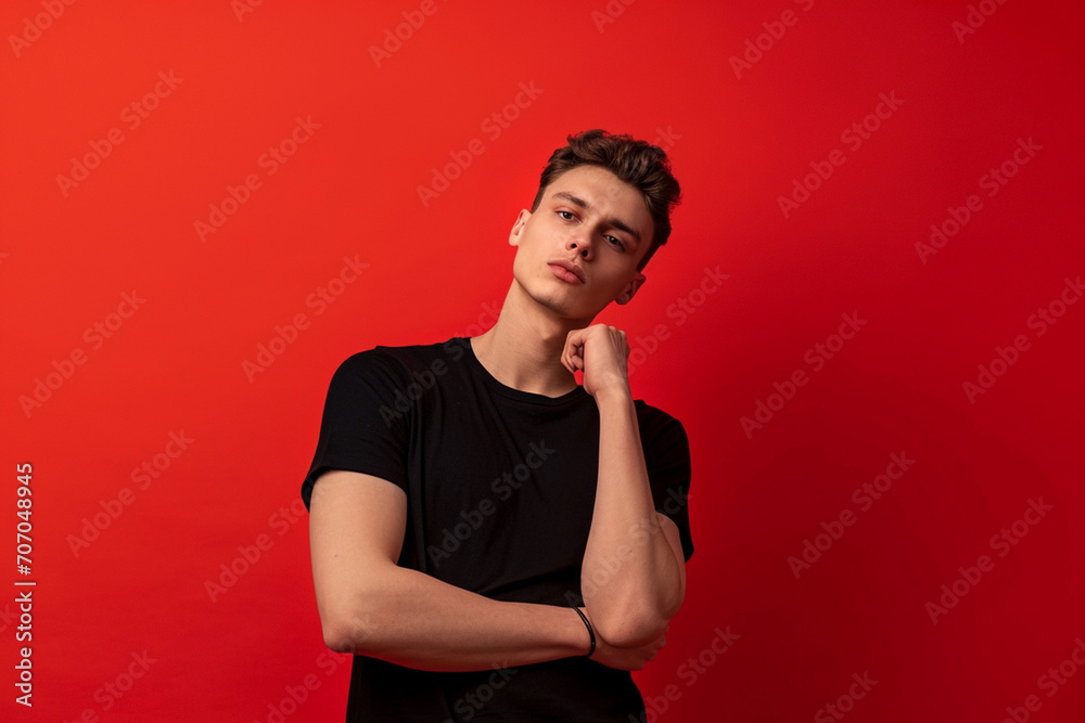 Fashion young man in studio giving pose on isolated color background Fashion young man in studio giving pose on isolated color background