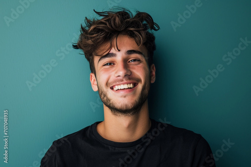 Fashion young man in studio giving pose on isolated color background