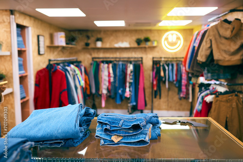 Display of Blue Denim Jeans On Counter In Fashion Or Clothes Store photo