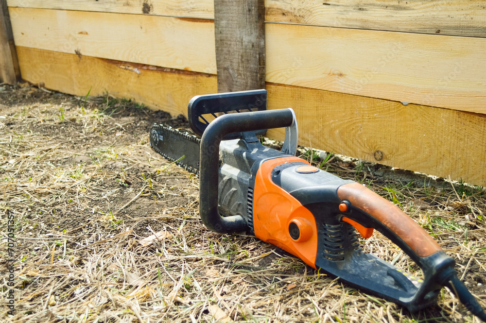 power saw lies near wooden formwork on the ground at a construction site