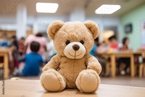 Teddy bear toy with blurry room with children iin children day care center, kindergarten or preschool´in background