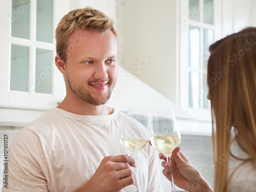 Happy young couple enjoying a glass of white wine