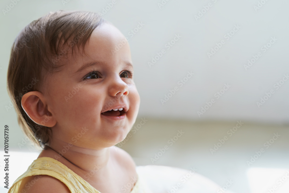 Baby, girl and curious or happy toddler at home, child development and growth in childhood. Female person, healthy kid and sweet or positive at house, peaceful and cheerful for care or relaxing