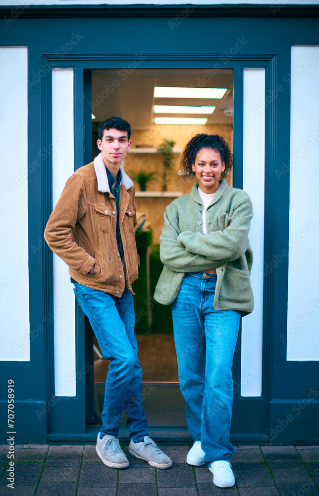 Portrait Of Sales Assistants Or Owners Standing Outside Fashion Or Clothes Store Portrait Of Sales Assistants Or Owners Standing Outside Fashion Or Clothes Store