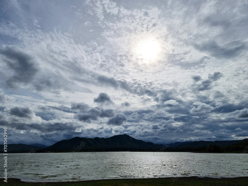 The landscape of the sunset with mountain and the reservoir on clouds in the sky background