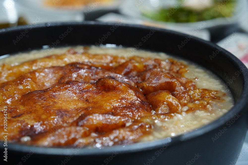 The thin crust of overcooked rice left at the bottom of a heated rice ...