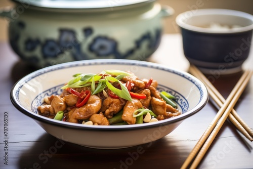 kung pao chicken in a traditional chinese serving dish
