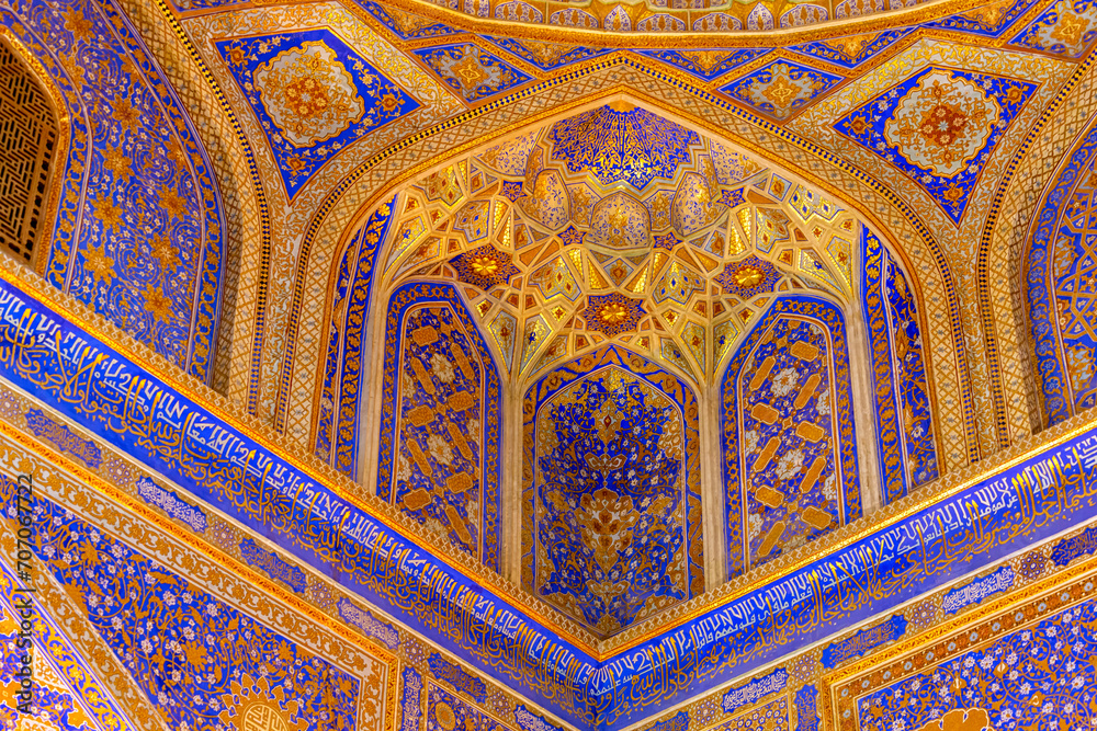 Interior of Tilya Kori Madrasah in Registan. Masterpiece of XVII century. Golden and blue. Arabic text of Qran (sacred book of muslims) used as part of ornament. April 24, 2023. Samarkand, Uzbekistan