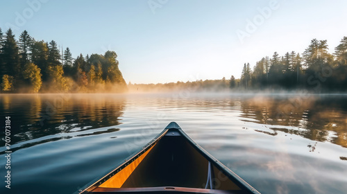 Bow of a canoe in the morning on a misty lake in Ontario, Canada.