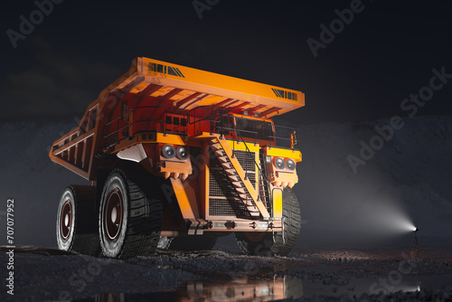Illuminated Heavy-Duty Mining Dump Truck on Rough Terrain at Dusk