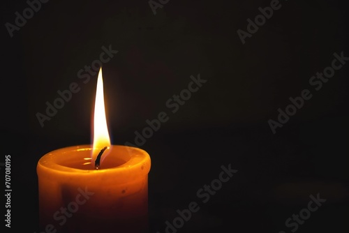 Candle flame flickering in a dark room