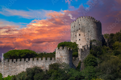 Majestic Medieval European Castle at Sunrise, Ancient Stone Fortress with Circular Tower on Green Hill