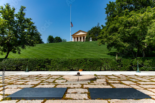 The two graves of John F. Kennedy and his wife with the eternal flame at the Arlington National Military Cemetery memorial in Washington DC, (USA).