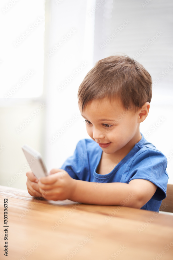 Child, boy and relaxing on smartphone or texting, connection and playing games on technology. Male person, home and mobile application for social media, browsing website and scrolling on internet Child, boy and relaxing on smartphone or texting, connection and playing games on technology. Male person, home and mobile application for social media, browsing website and scrolling on internet