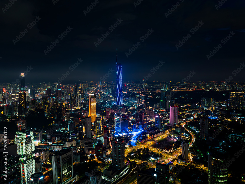 Obraz premium An high angle aerial view of the tallest Skyscrapper in south east asia during night with colorful light and laser show