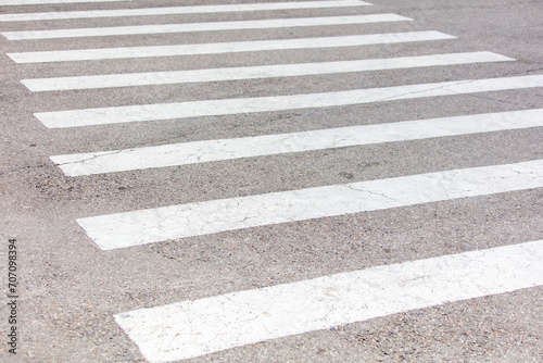 White stripes on an asphalt road. Crosswalk